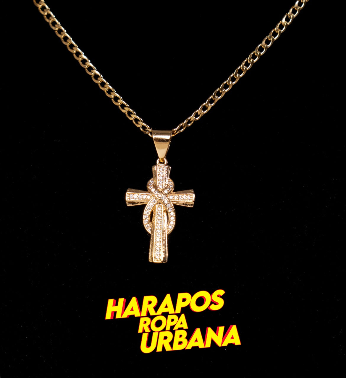 Cadena acero y dije cruz lazo enredado dorada